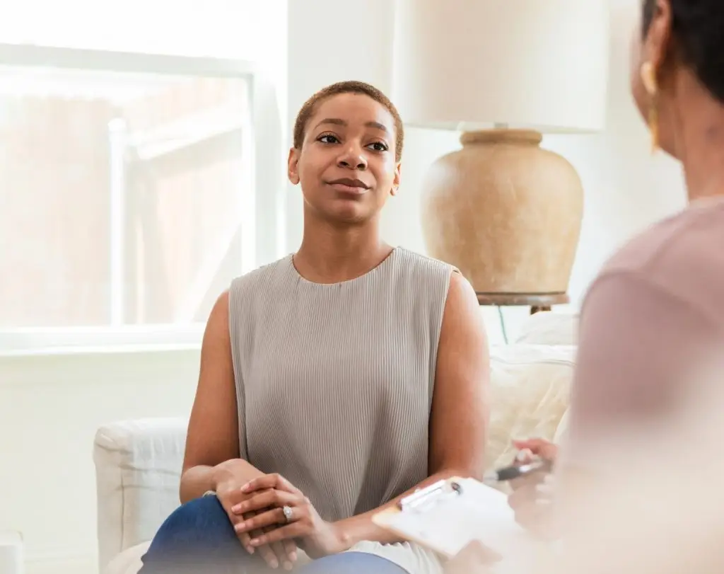 Patient and therapist in discussion during counseling session. Mental health and emotional support.
